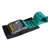 Close up product photo of teal tie down cam strap featuring a rollercam buckle, sewn gear loop, and buckle pad made from black seatbelt webbing.