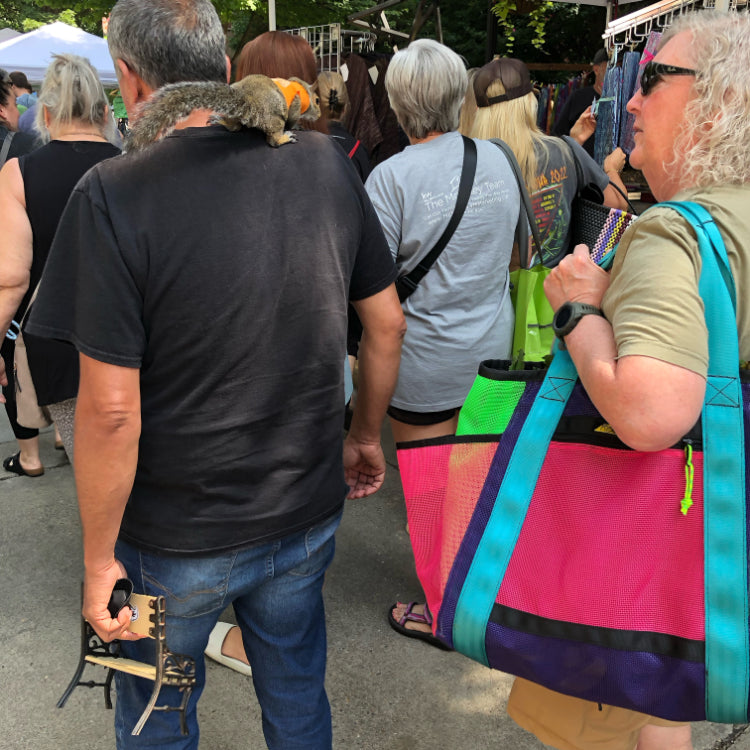 Squirrel on a shoulder next to tote bag