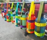 Multiple multi colored bottle slings lined up