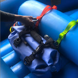 clipping a water bottle to a red orange polyester cam strap attached to whitewater raft thwart