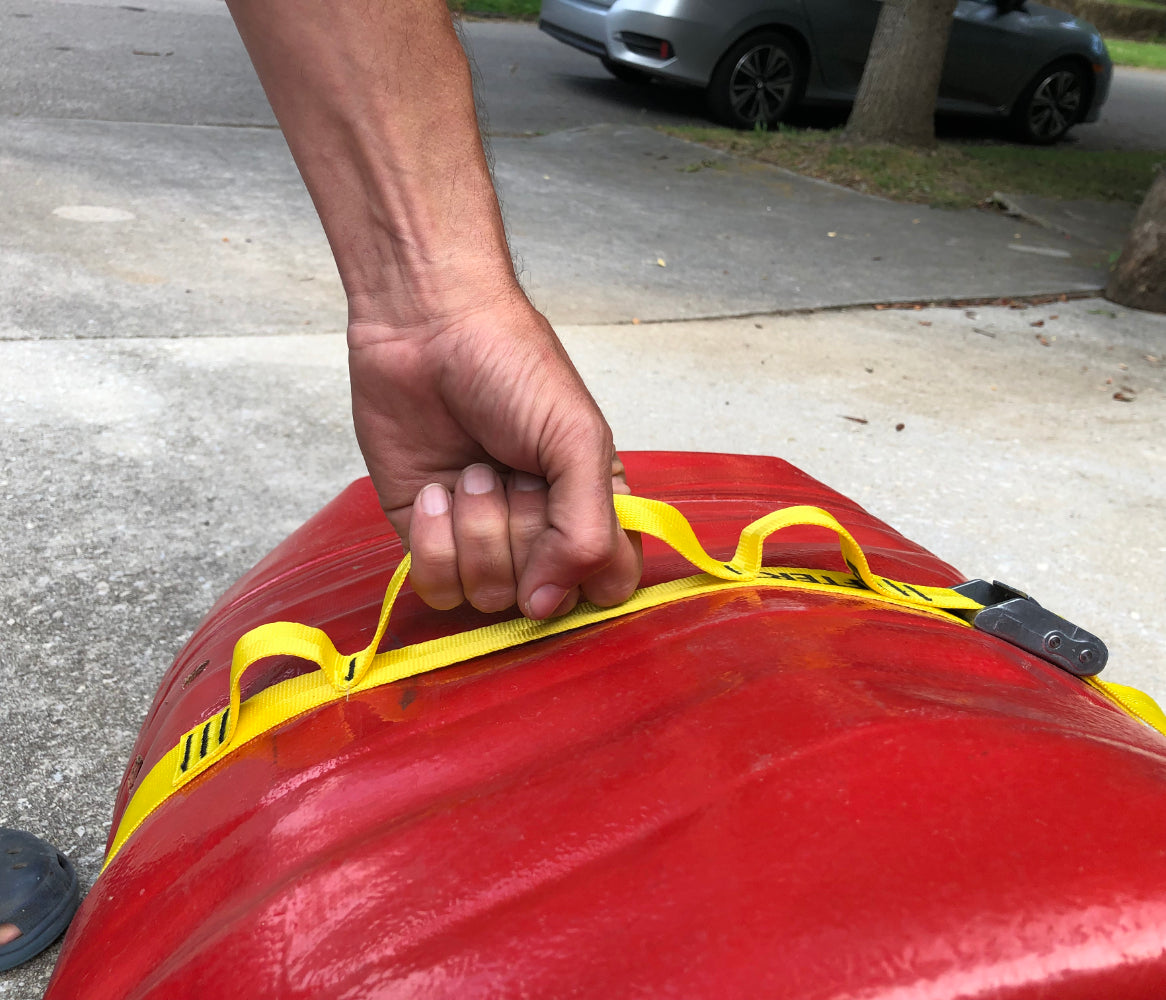 yellow polyester handle cam strap around rolled up inflatable kayak